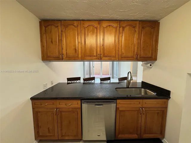 a kitchen with granite countertop cabinets and sink
