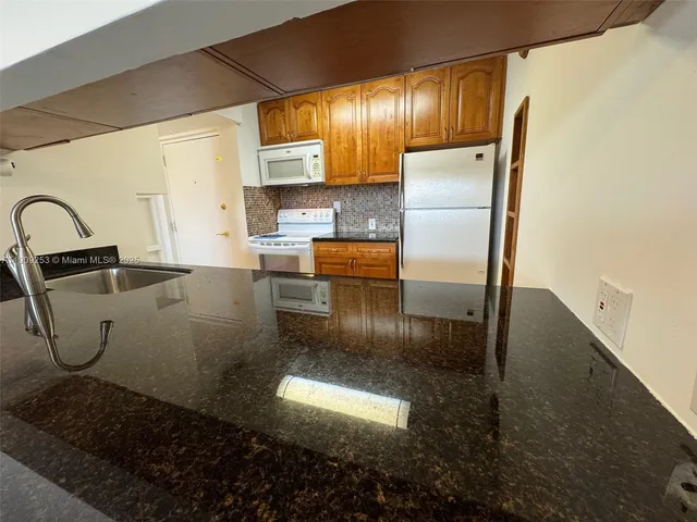a kitchen with refrigerator and window