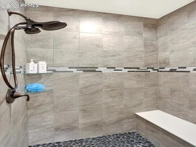 a bathroom with a tub a sink and a window