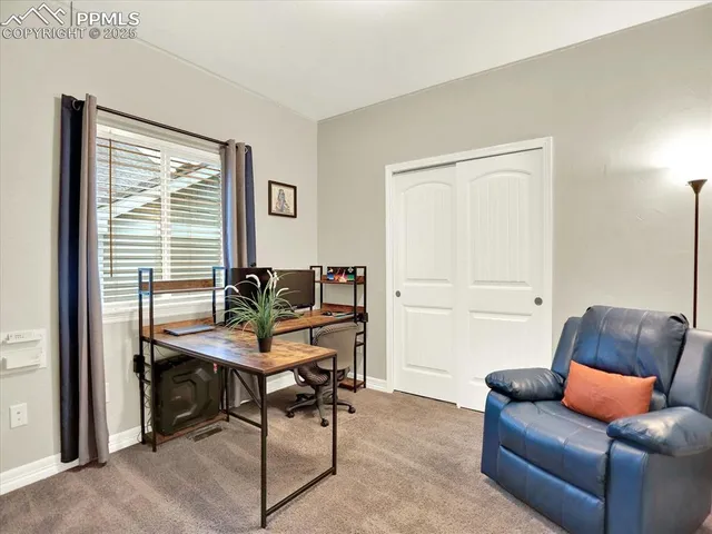 a view of a workspace with a window and cabinet