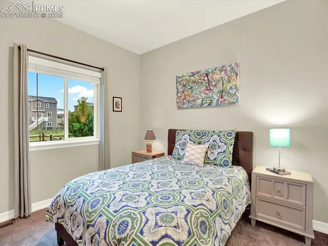 a bedroom with a bed and a flat tv screen on dresser