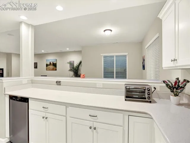 a bedroom with a bed window and dresser