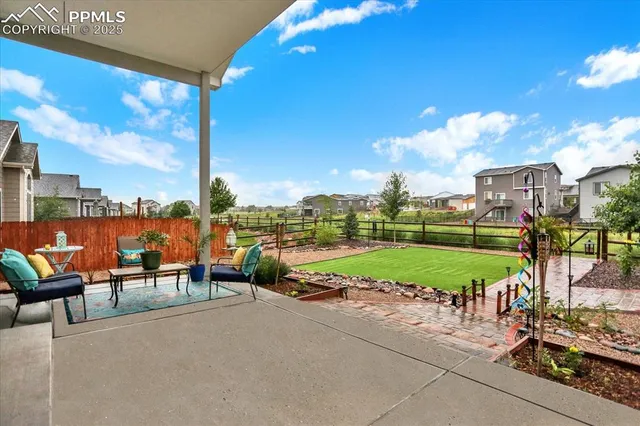 a backyard of a house with barbeque oven table and chairs
