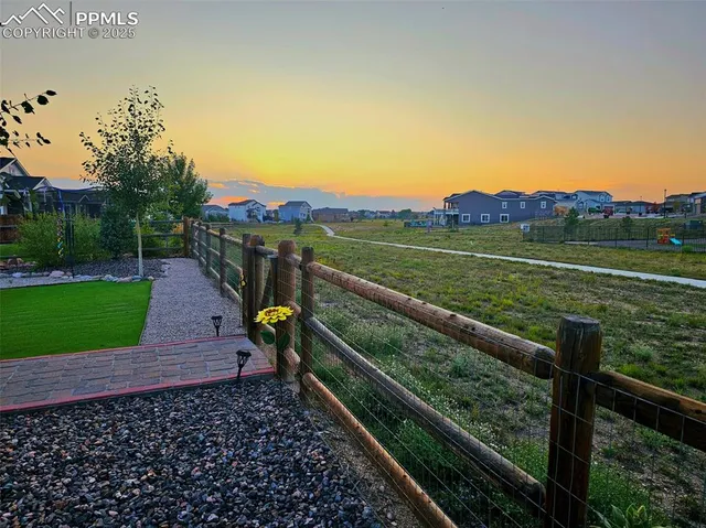 a view of a house with pool and a yard