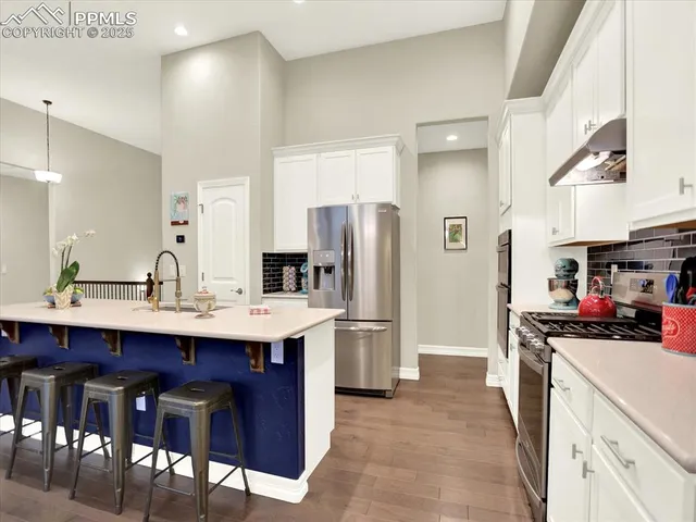 a kitchen with a sink stainless steel appliances and cabinets