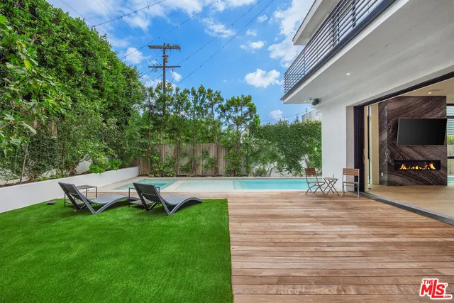 a view of a backyard with sitting area