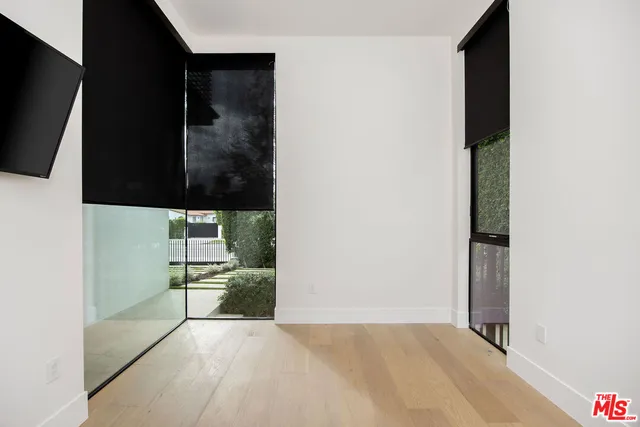 a view of hallway with table and chairs
