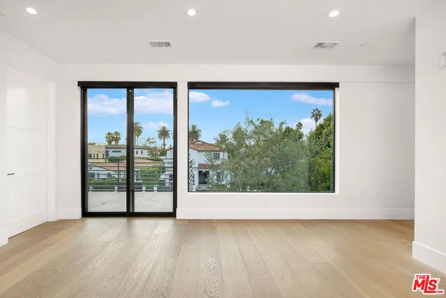 a view of a room with wooden floor and window