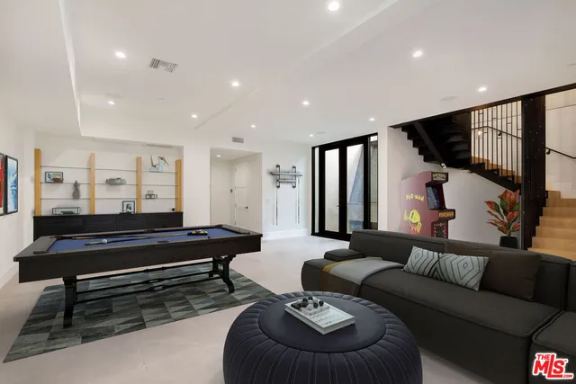 a living room with furniture and a piano