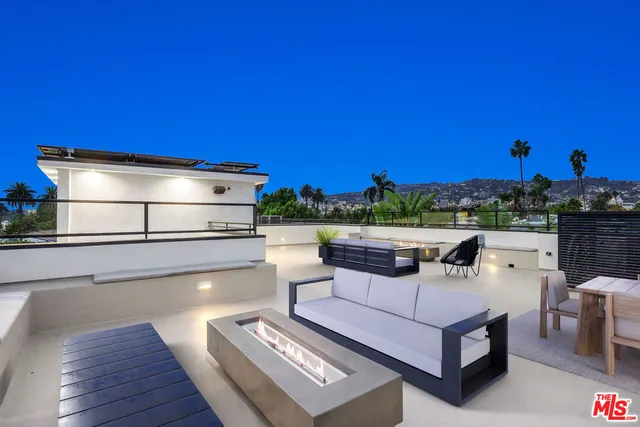 a view of a living room with furniture and a floor to ceiling window
