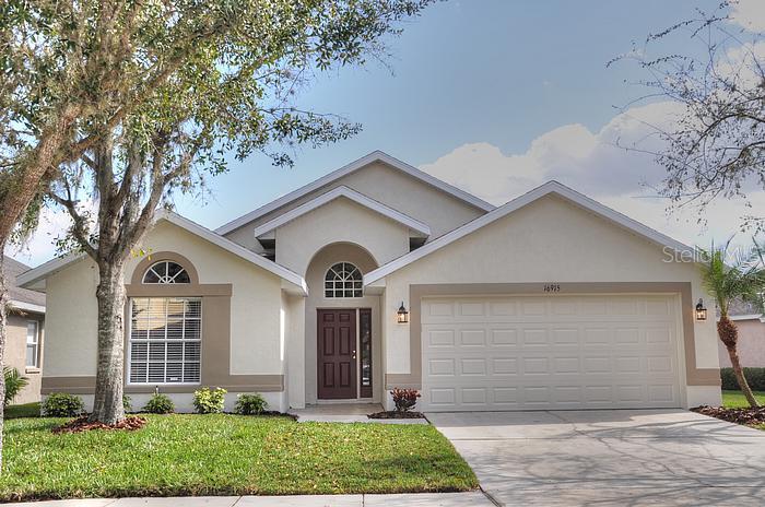 16915 Hawkridge Road Lithia, FL 33547 - Photo 1 of 1 a front view of a house with garden
