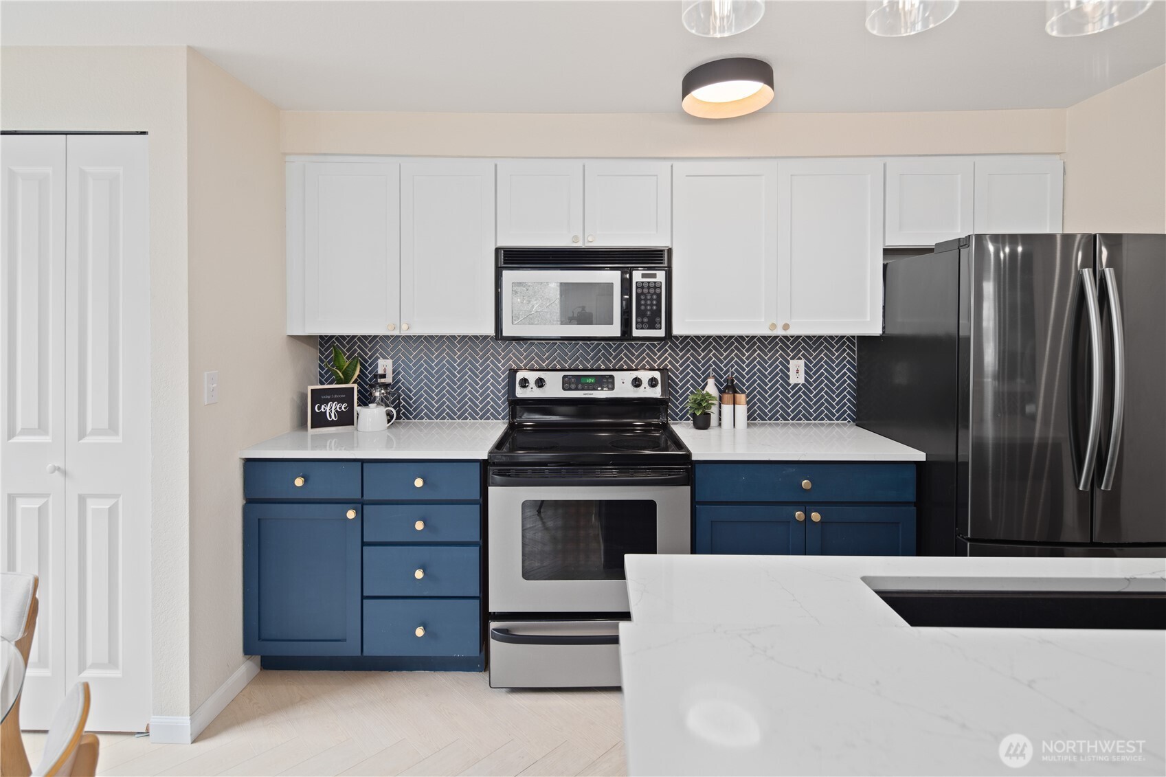 300 10th Avenue, Unit A302 Seattle, WA 98122 - Photo 14 of 27 a kitchen with stainless steel appliances a stove a refrigerator and a cabinets