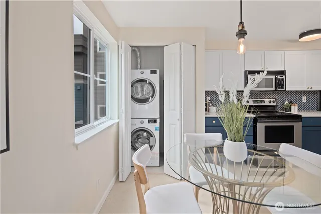 a bathroom with a granite countertop sink vanity mirror and toilet