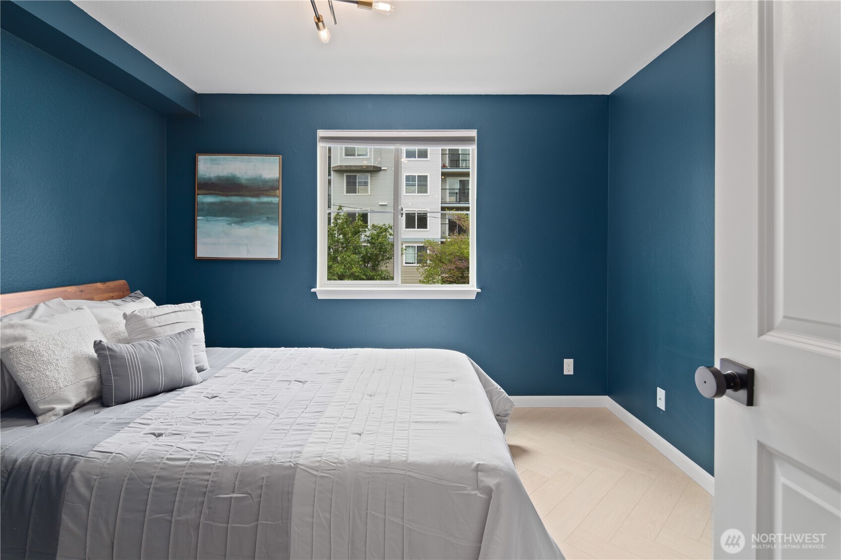 300 10th Avenue, Unit A302 Seattle, WA 98122 - Photo 16 of 27 a bedroom with a bed and a window