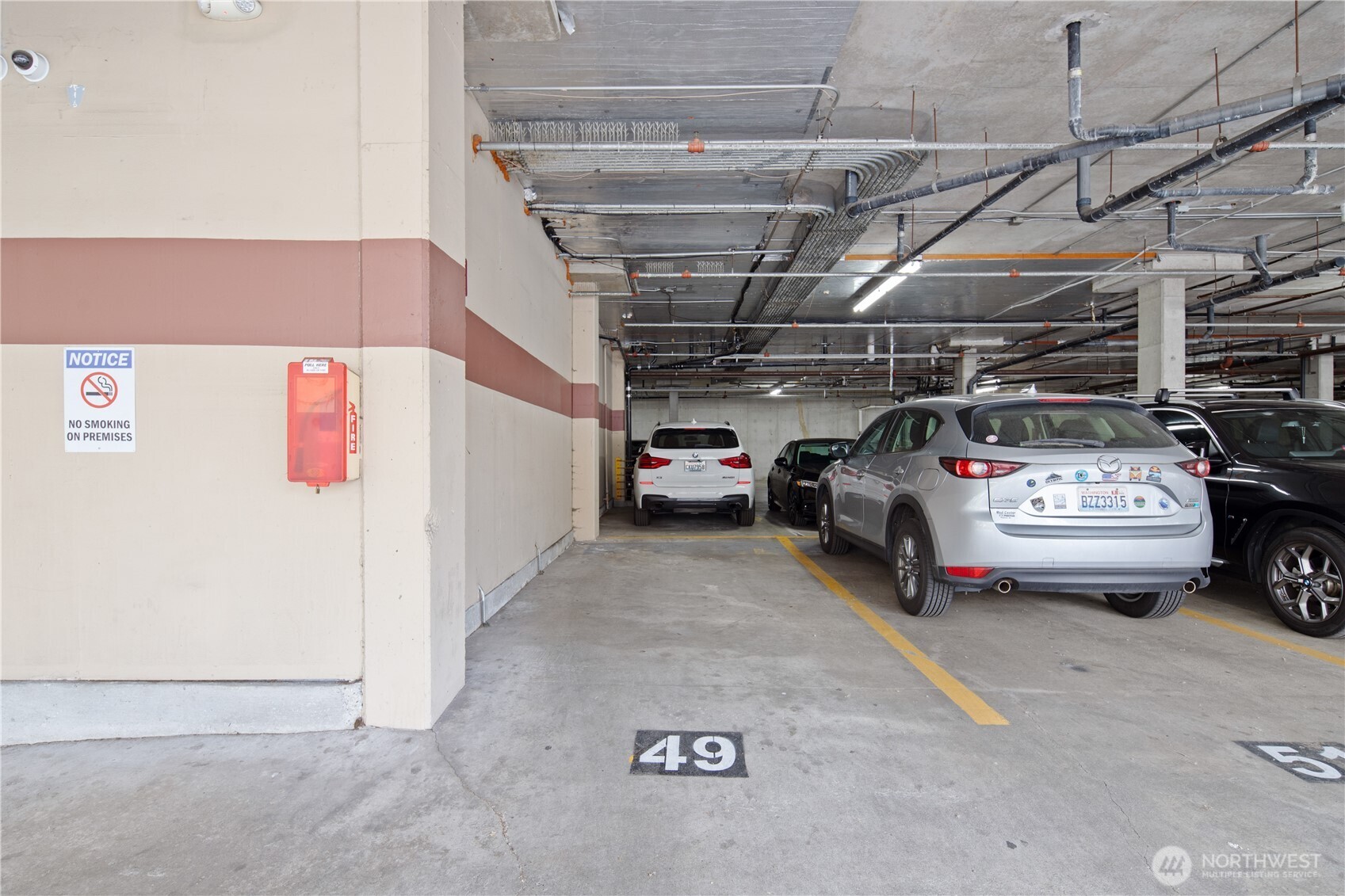 300 10th Avenue, Unit A302 Seattle, WA 98122 - Photo 18 of 27 a view of parking garage with cars