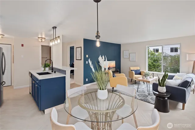 a living room with furniture a chandelier and a dining table