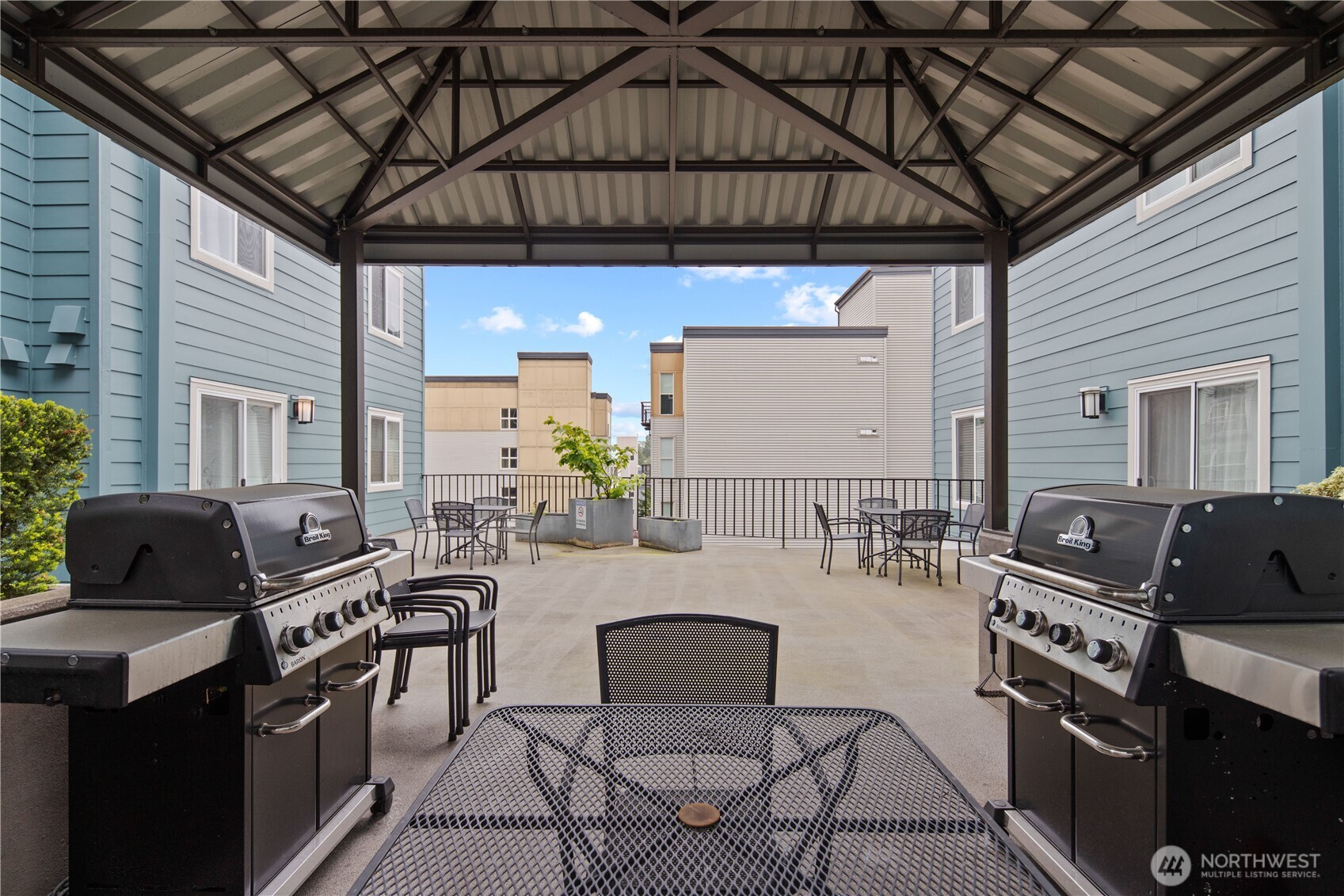 300 10th Avenue, Unit A302 Seattle, WA 98122 - Photo 21 of 27 a kitchen with table chairs stove and cabinets