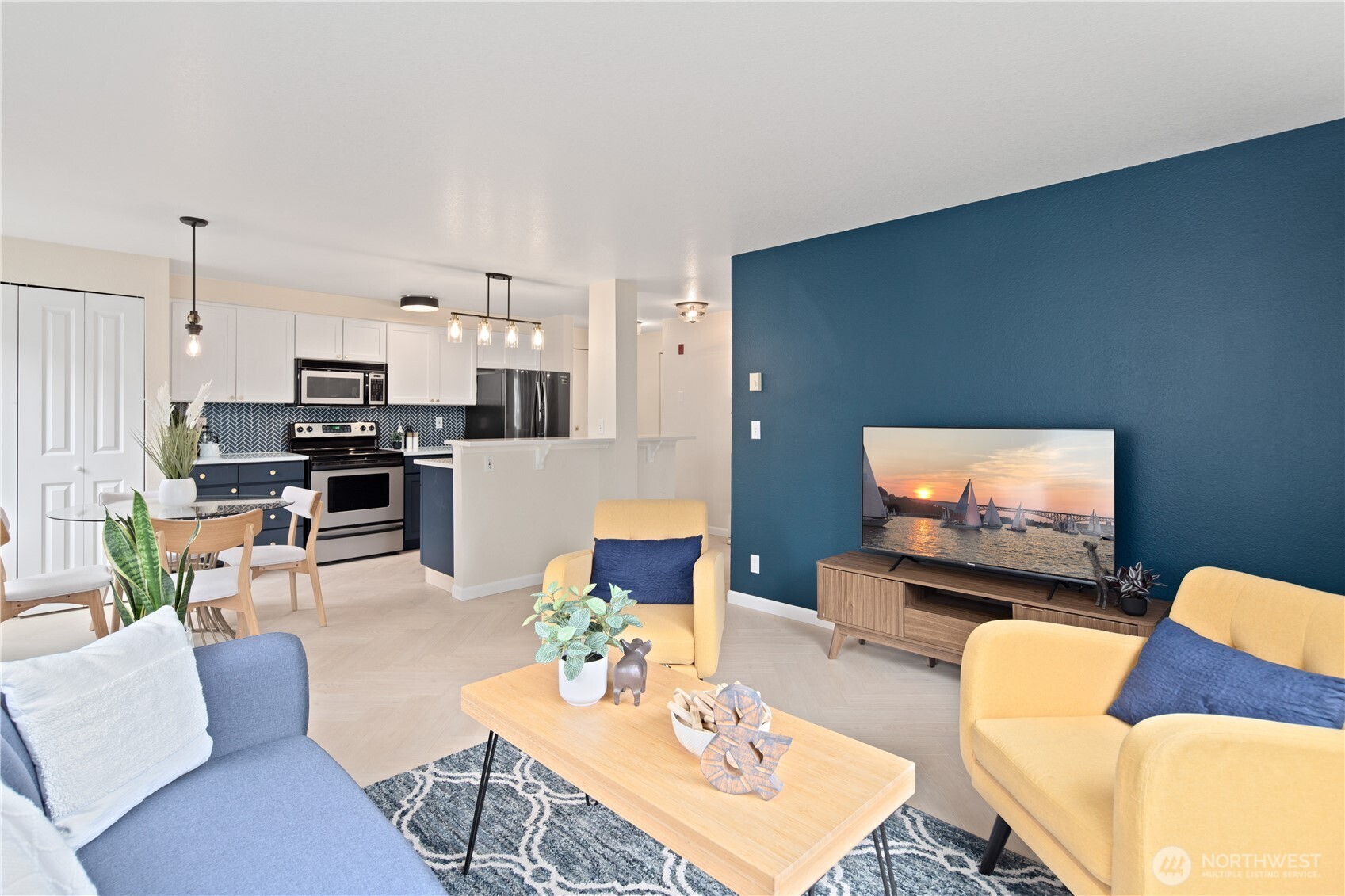 300 10th Avenue, Unit A302 Seattle, WA 98122 - Photo 4 of 27 a living room with furniture kitchen view and a flat screen tv