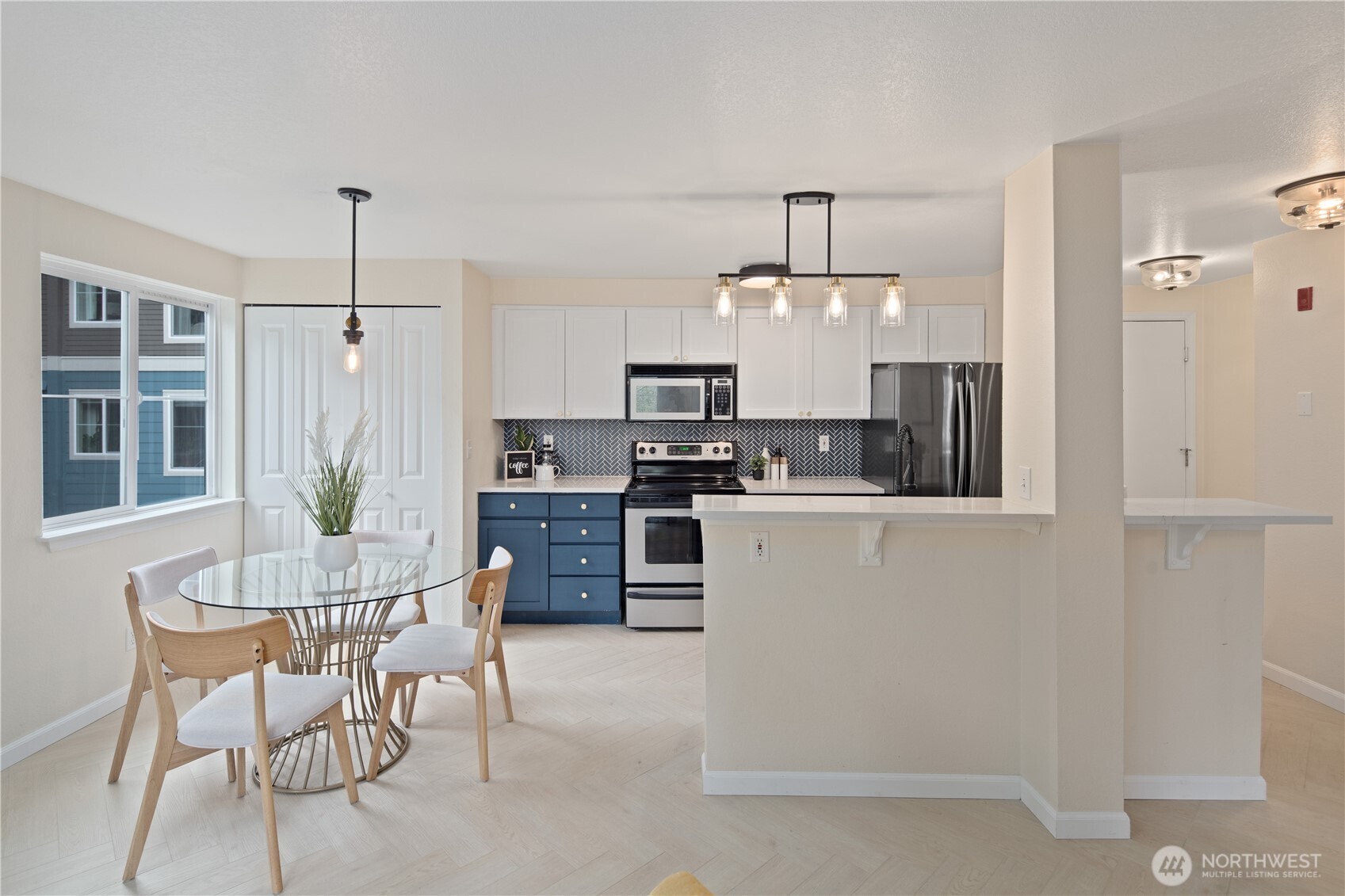 300 10th Avenue, Unit A302 Seattle, WA 98122 - Photo 7 of 27 a kitchen with kitchen island granite countertop a sink cabinets and stainless steel appliances