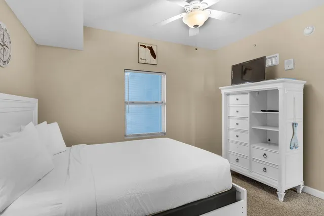 a bedroom with a bed and a tv