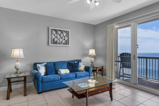 a living room with furniture a lamp and a window