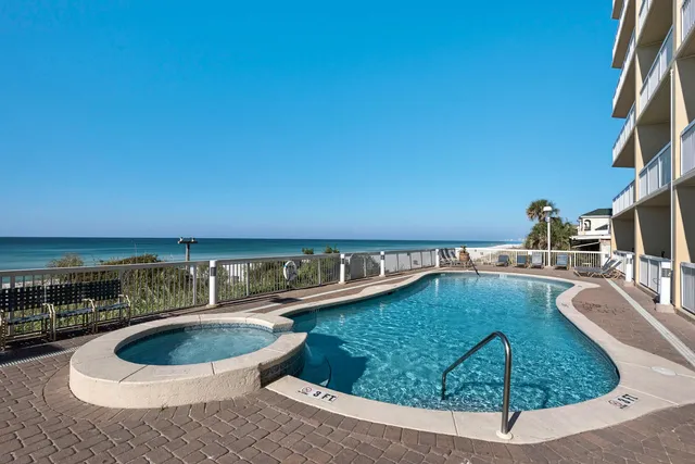 a view of a swimming pool with outdoor seating