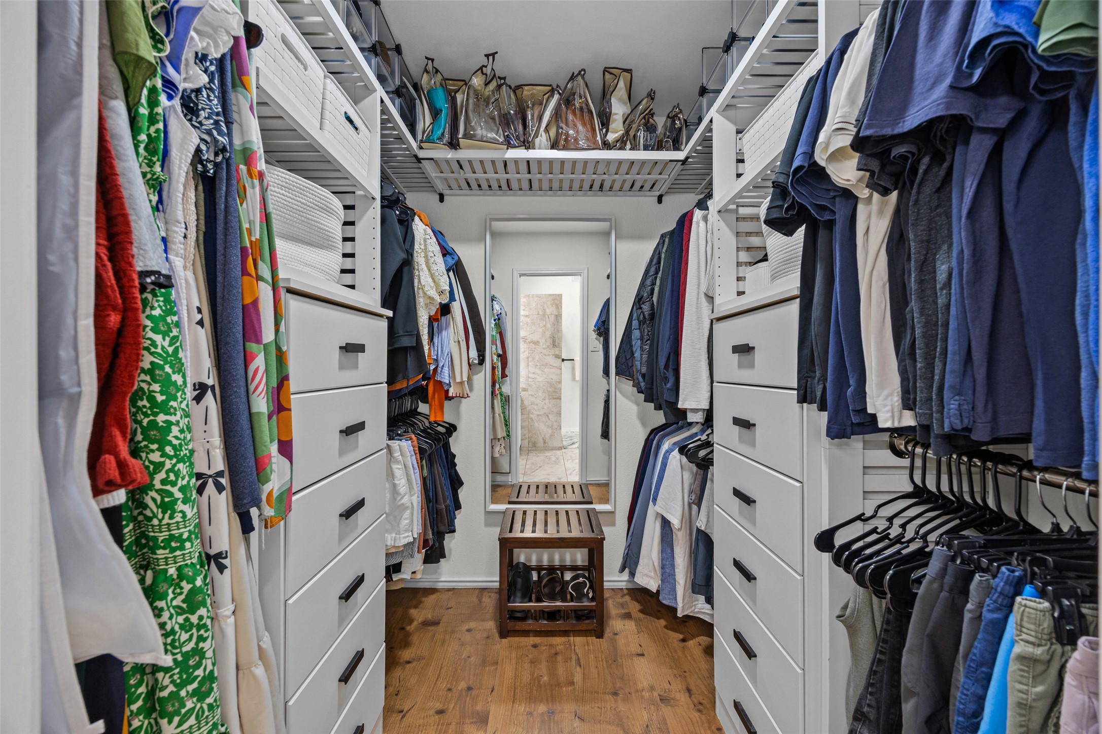 3006 Overland Street Round Rock, TX 78681 - Photo 14 of 29 A spacious walk-in closet includes custom white cabinetry and warm wood flooring.