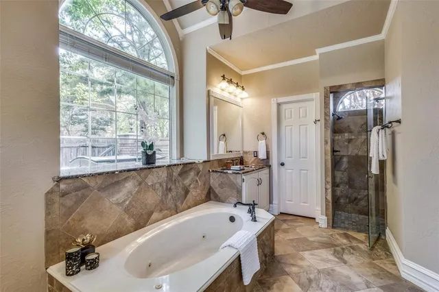 a bathroom with a tub a sink and a large mirror