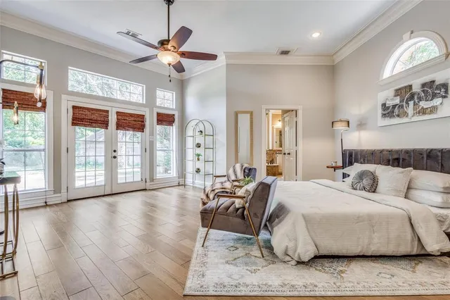 a spacious bedroom with a large bed and a large window