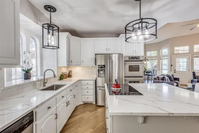 a kitchen with refrigerator a sink and stove