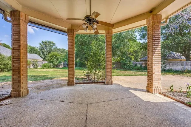 a view of a house with a big yard and a fountain