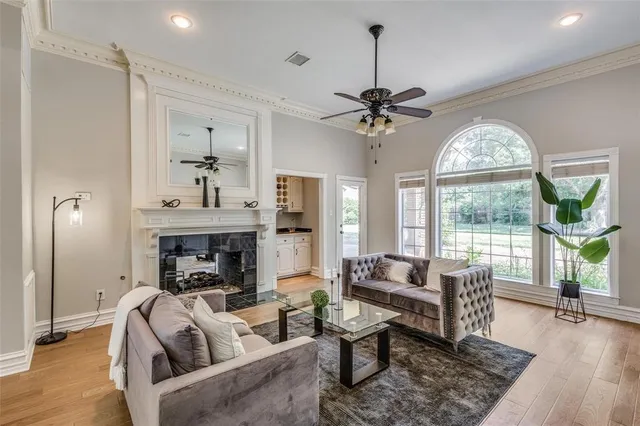 a living room with furniture fireplace and a large window
