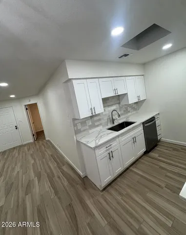 a kitchen with a sink and cabinets