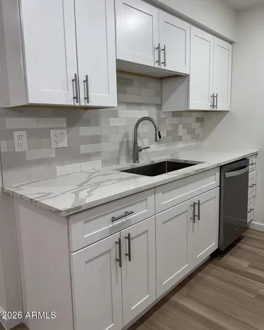 a kitchen with white cabinets and white appliances