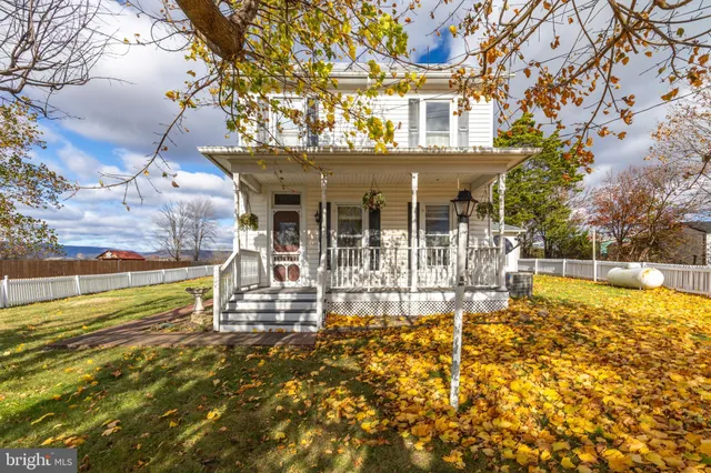 a view of a house with pool and sitting area