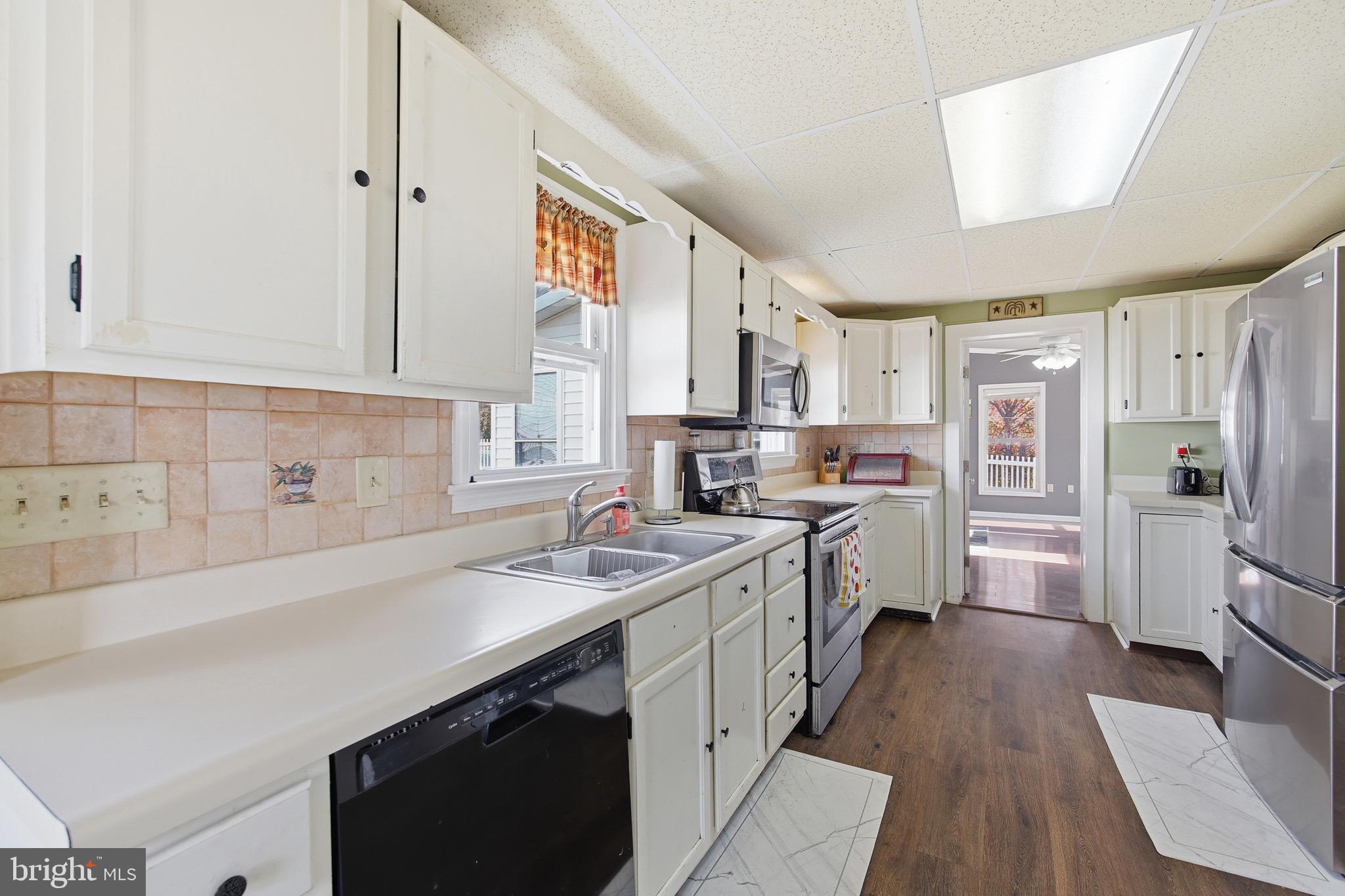 24295 Senedo Road Woodstock, VA 22664 - Photo 13 of 43 a kitchen with stainless steel appliances a sink stove refrigerator and cabinets