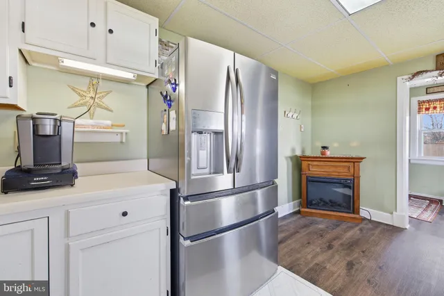 a kitchen with stainless steel appliances a stove a refrigerator and cabinets