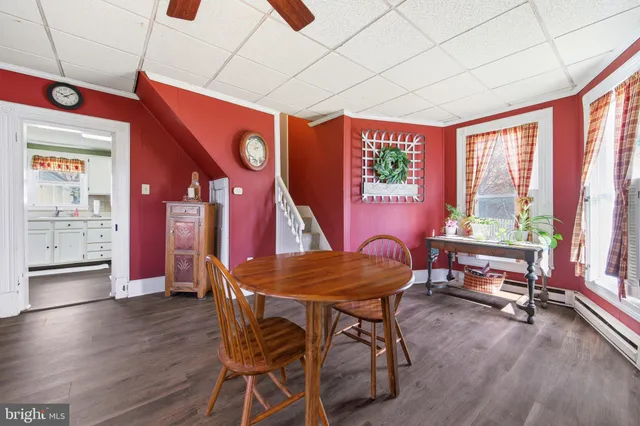 a dining room with furniture and wooden floor