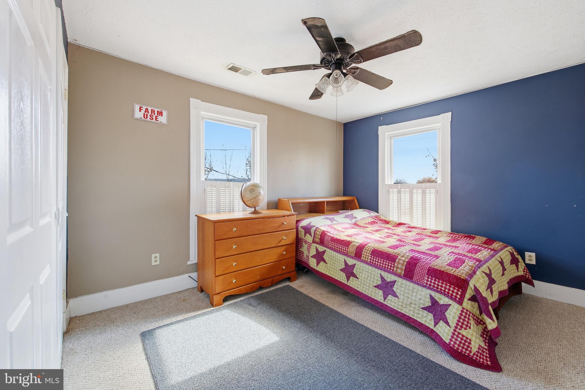 24295 Senedo Road Woodstock, VA 22664 - Photo 26 of 43 a bedroom with a bed and a chandelier