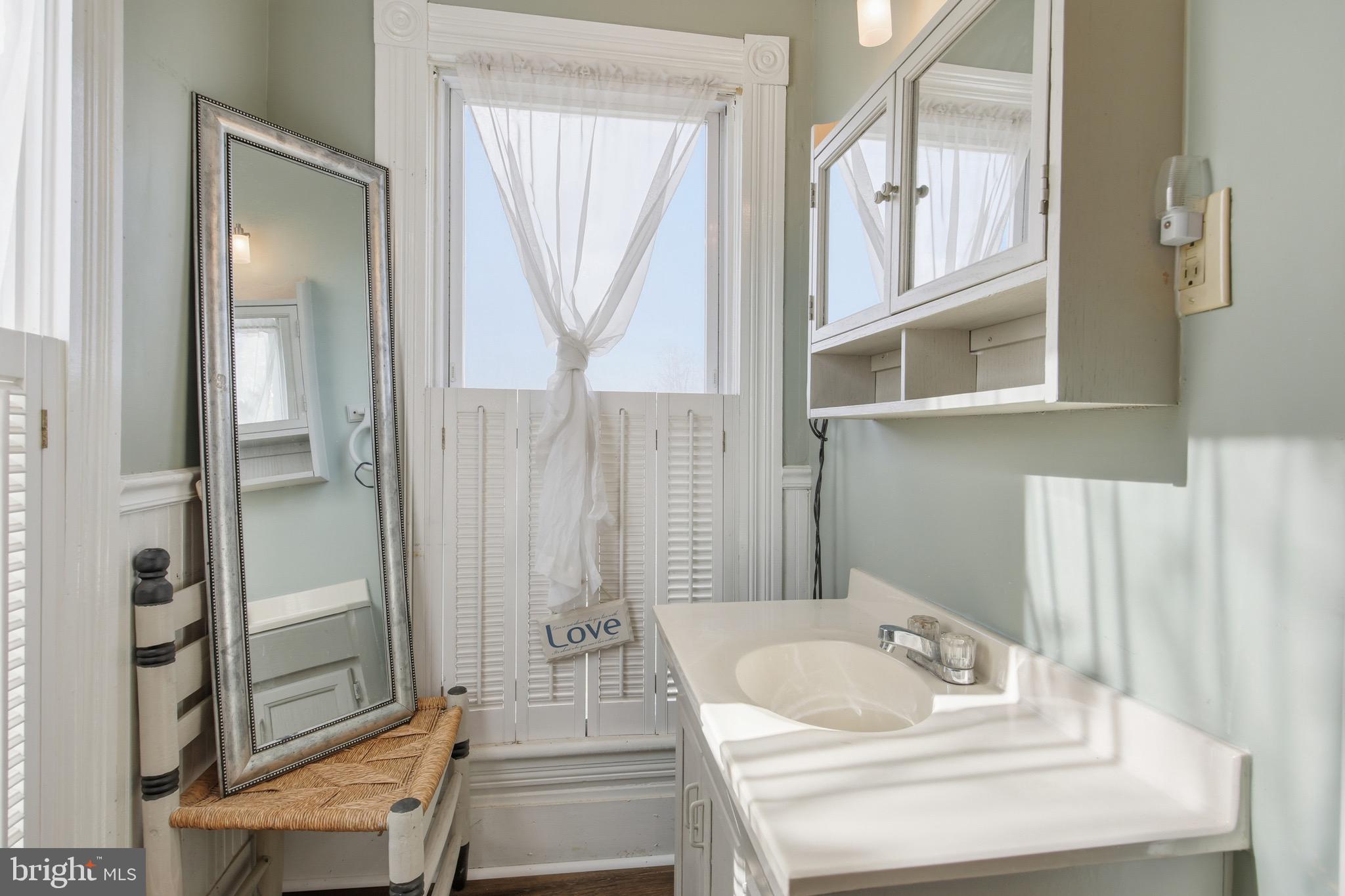 24295 Senedo Road Woodstock, VA 22664 - Photo 29 of 43 a bathroom with a tub sink and mirror