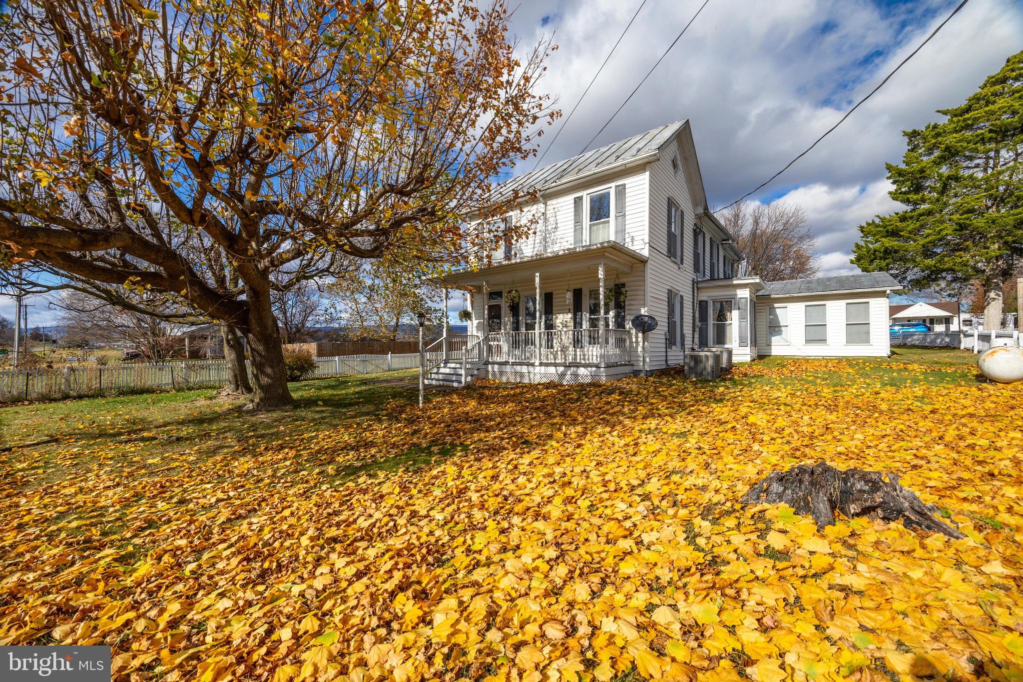 24295 Senedo Road Woodstock, VA 22664 - Photo 43 of 43 a front view of a house with a yard fountain and large tree