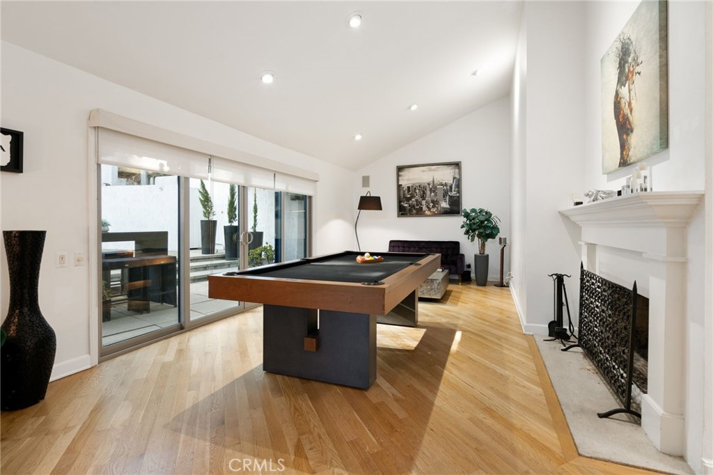 1447 North Kings Road West Hollywood, CA 90069 - Photo 12 of 40 a living room with furniture a fireplace and a flat screen tv