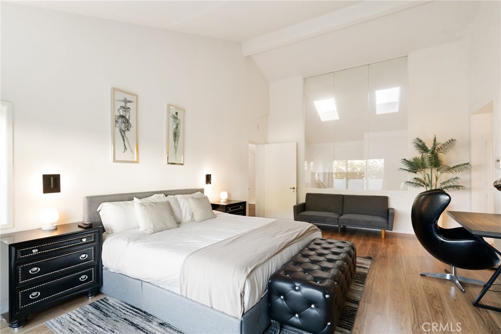 1447 North Kings Road West Hollywood, CA 90069 - Photo 16 of 40 a bedroom with a bed and dresser with mirror