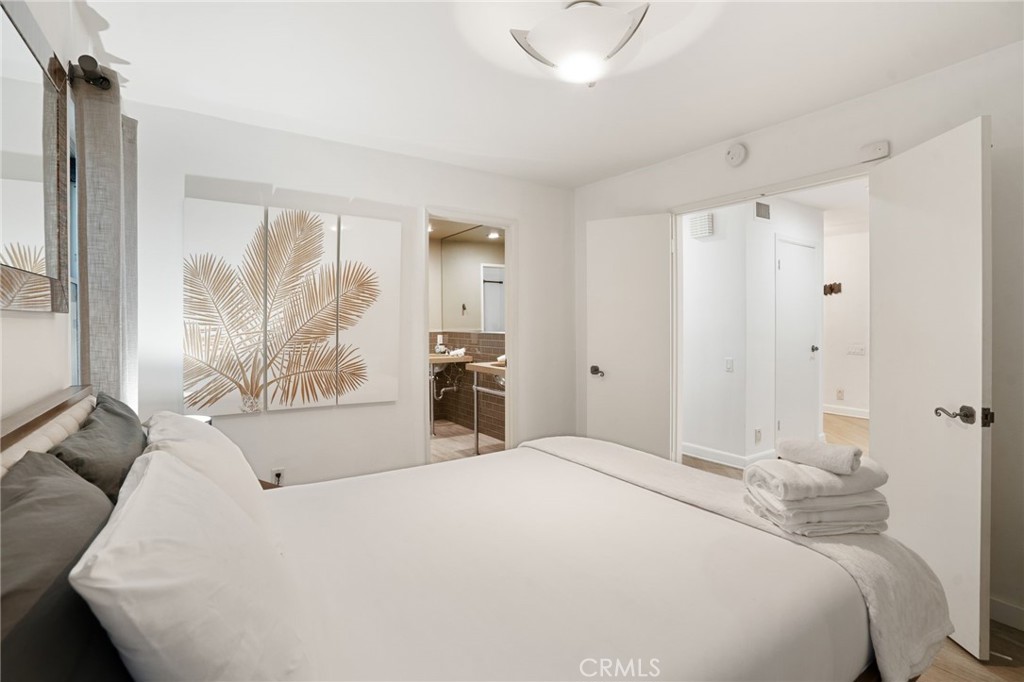 1447 North Kings Road West Hollywood, CA 90069 - Photo 23 of 40 a bedroom with a large bed and a large window