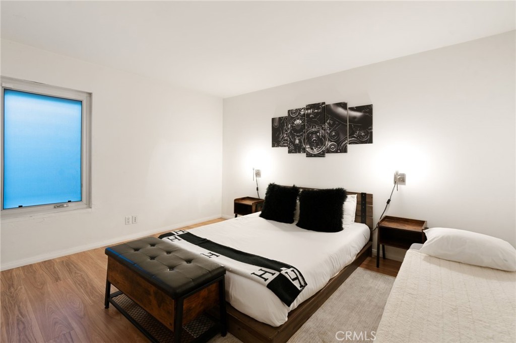 1447 North Kings Road West Hollywood, CA 90069 - Photo 24 of 40 a bedroom with a bed and wooden floor