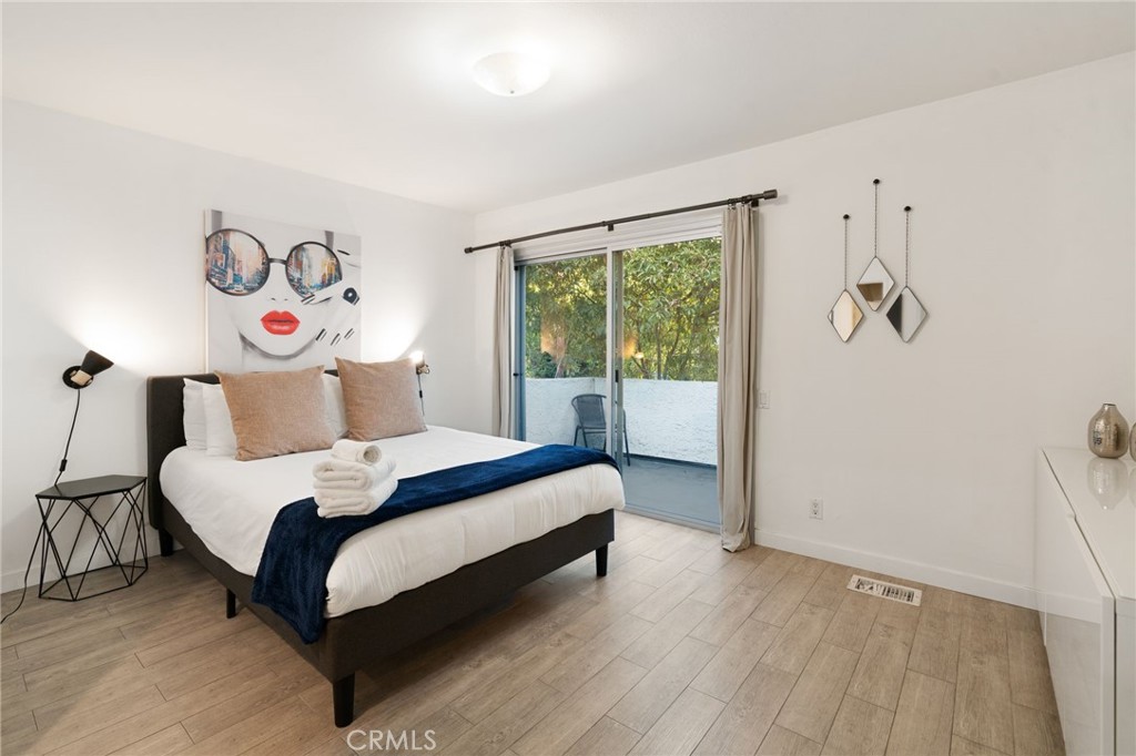 1447 North Kings Road West Hollywood, CA 90069 - Photo 32 of 40 a bedroom with a bed and a window