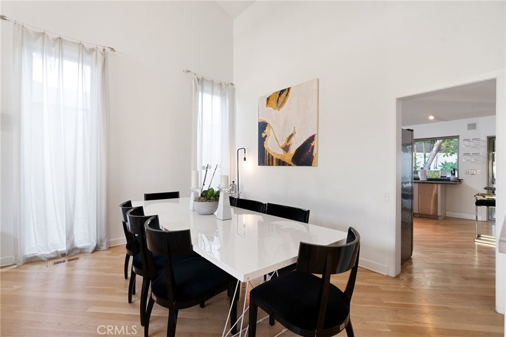 1447 North Kings Road West Hollywood, CA 90069 - Photo 8 of 40 a view of a dining room with furniture and wooden floor