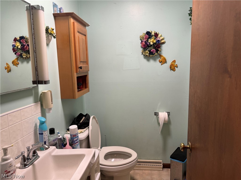 5320 North Ridge Road West Ashtabula, OH 44004 - Photo 11 of 33 Bathroom featuring backsplash, sink, toilet, and tile flooring