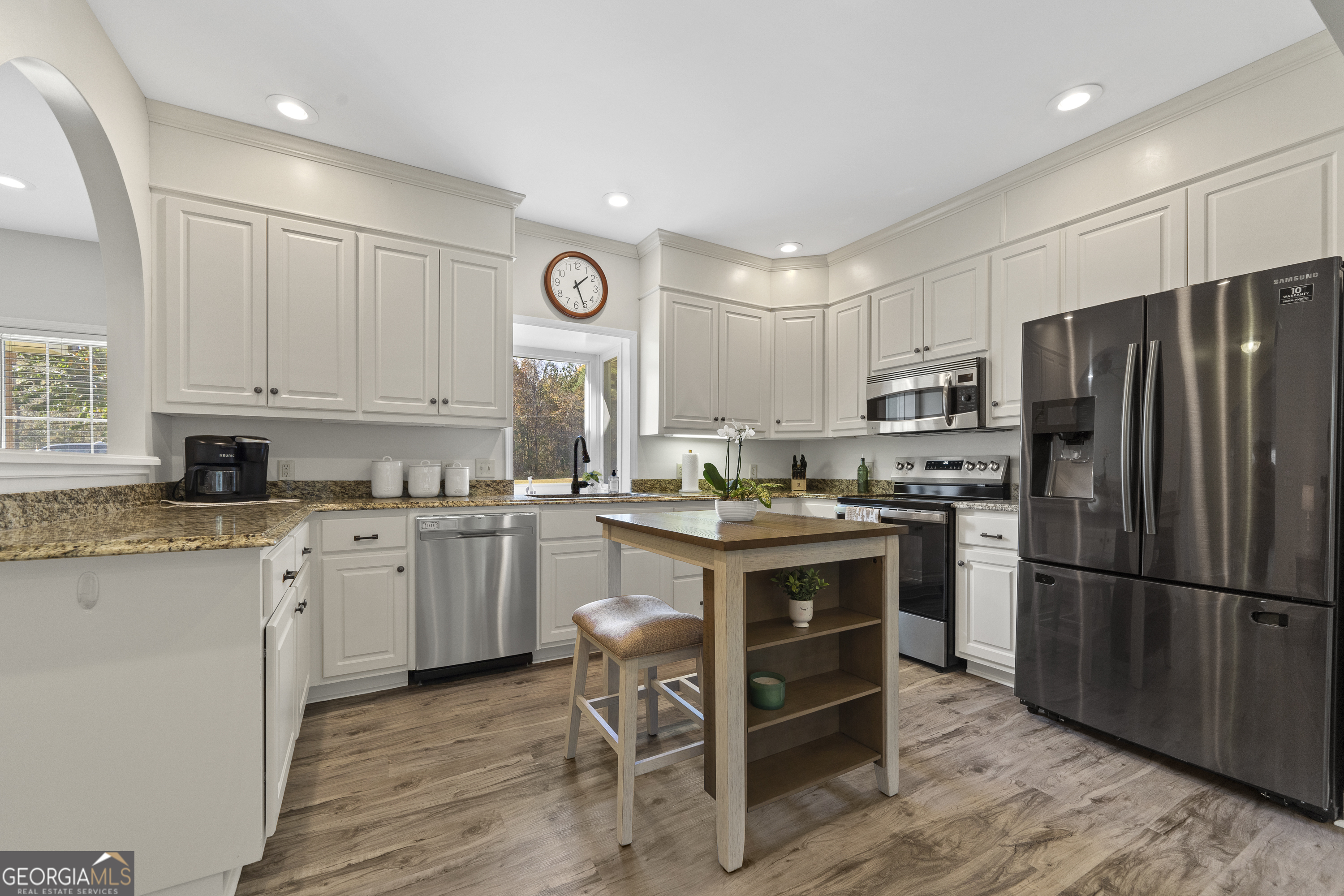 1050 Sugar Creek Church Road Madison, GA 30650 - Photo 12 of 60 a kitchen with a refrigerator stove microwave and cabinets