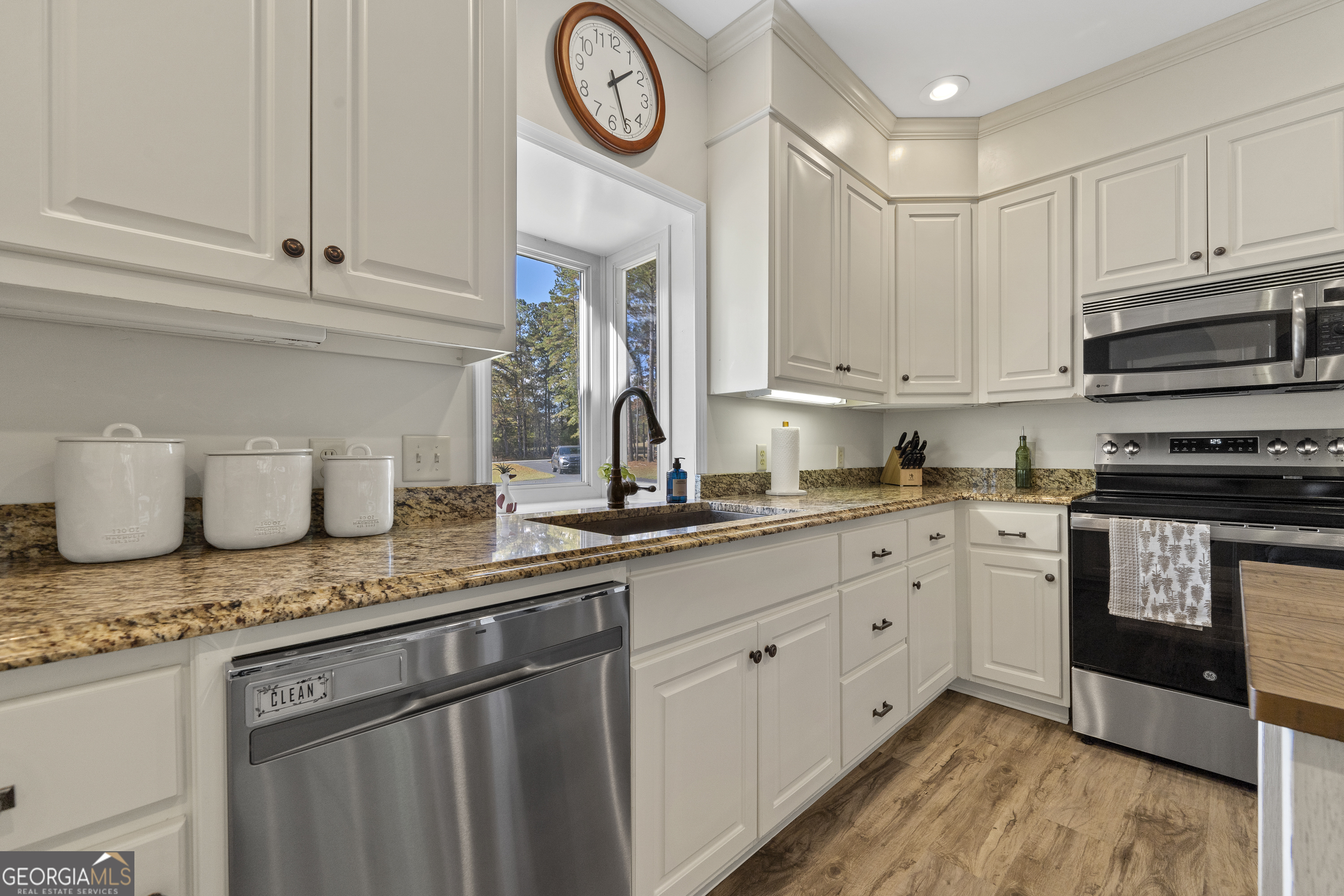 1050 Sugar Creek Church Road Madison, GA 30650 - Photo 13 of 60 a kitchen with granite countertop cabinets stainless steel appliances and a counter space